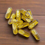 cannabis capsules on a wooden table