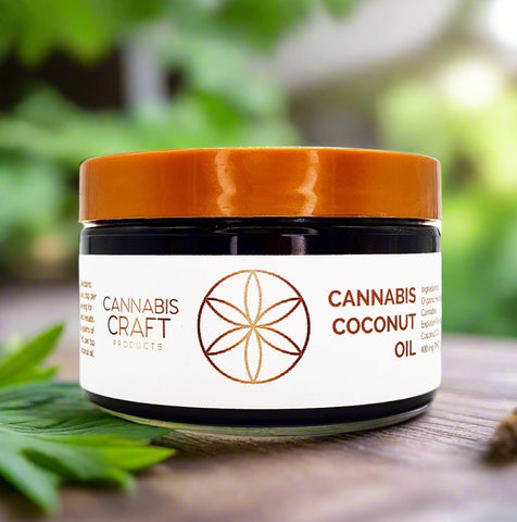A jar of Cannabis Coconut Oil with a white label, brown lid, and a cannabis leaf emblem.