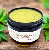 A jar of Cannabis Coconut Oil with a white label, brown lid, and a cannabis leaf emblem.
