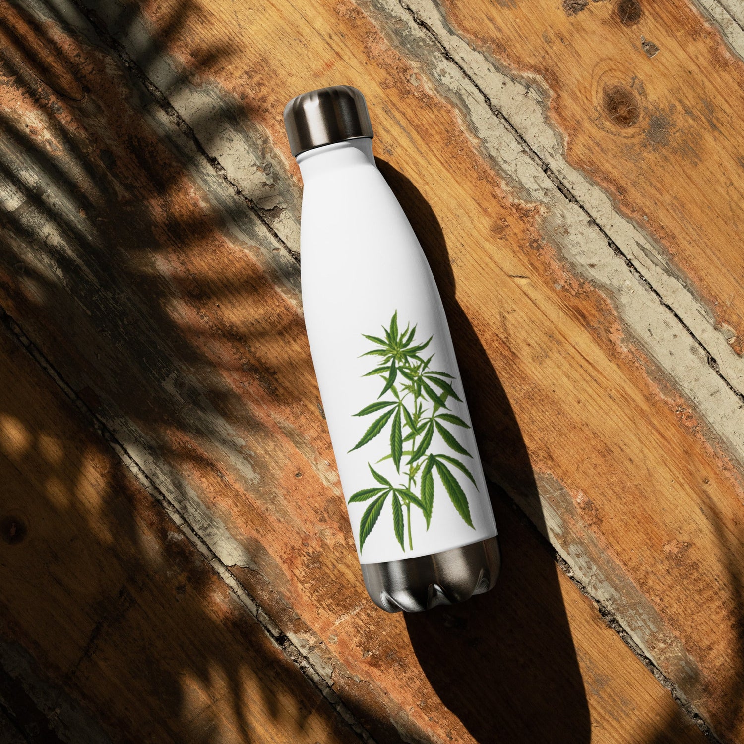 Cannabis Plant Steel Water Bottle on a wooden table outside in the sun