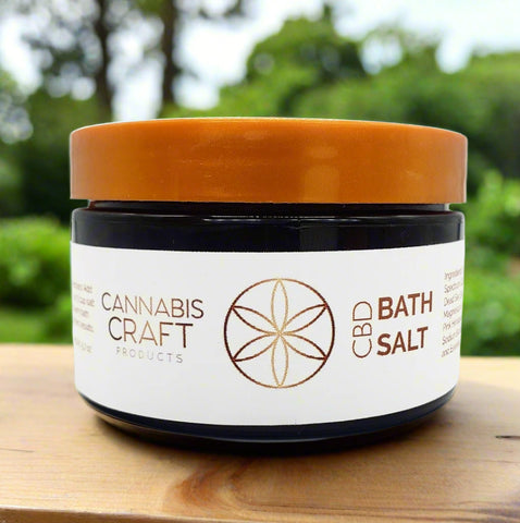 A jar of CBD BATH SALT by Cannabis Craft Products with a label that includes the product name and a symbol indicating the CBD content.